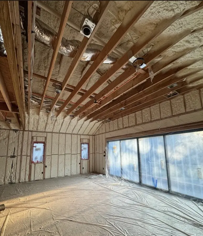 Interior walls and ceiling insulated with spray foam during new construction in Onondaga